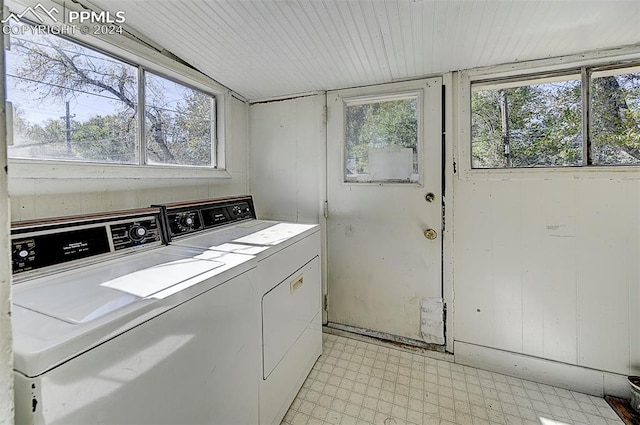 laundry room featuring separate washer and dryer, light tile patterned flooring, and plenty of natural light