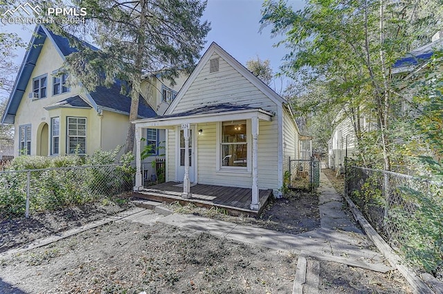 view of front of house with a porch and fence