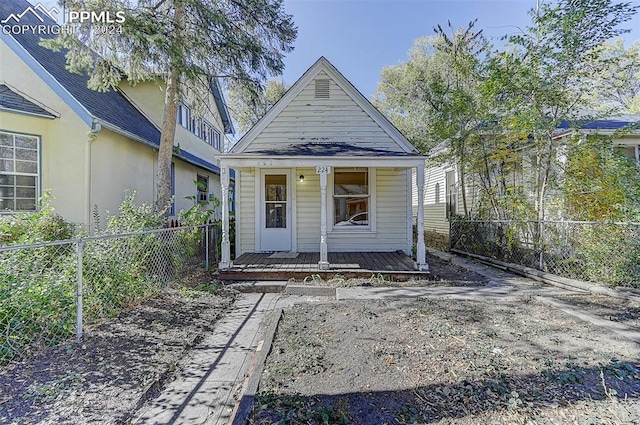 view of front of home featuring a porch and fence private yard