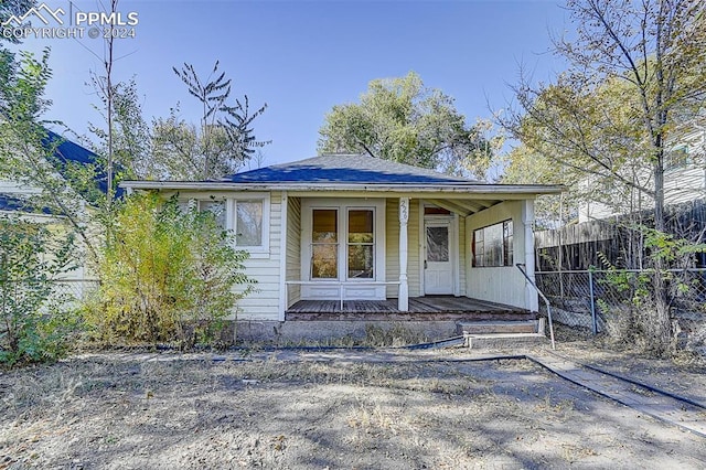 view of front facade with a porch and fence