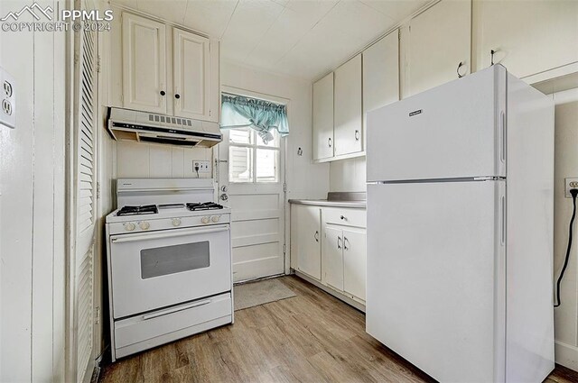 kitchen with white appliances, light hardwood / wood-style floors, and white cabinets