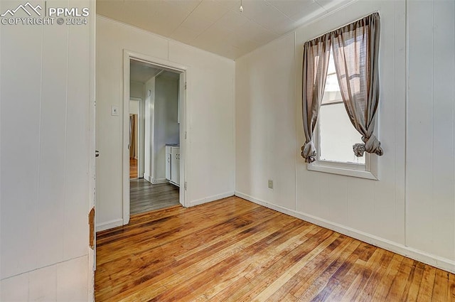 unfurnished room with hardwood / wood-style flooring