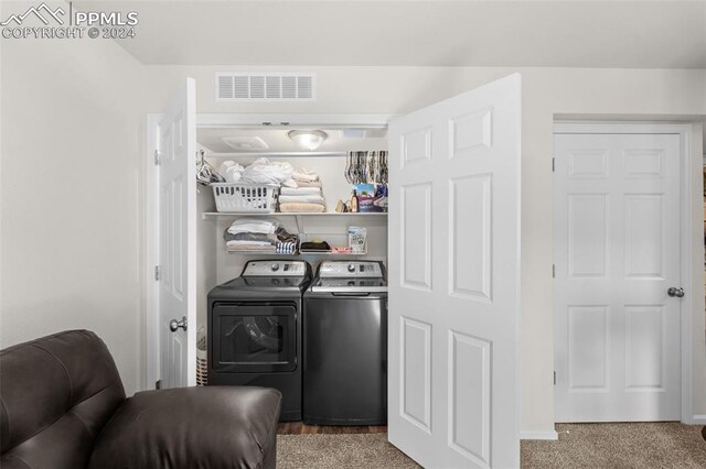 laundry area with carpet floors and washer and clothes dryer