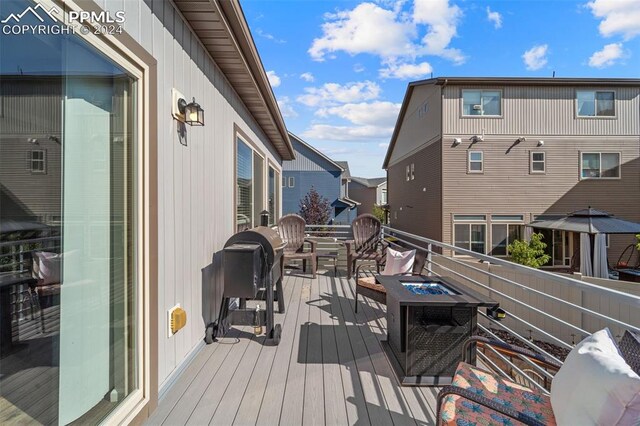 wooden deck with a fire pit