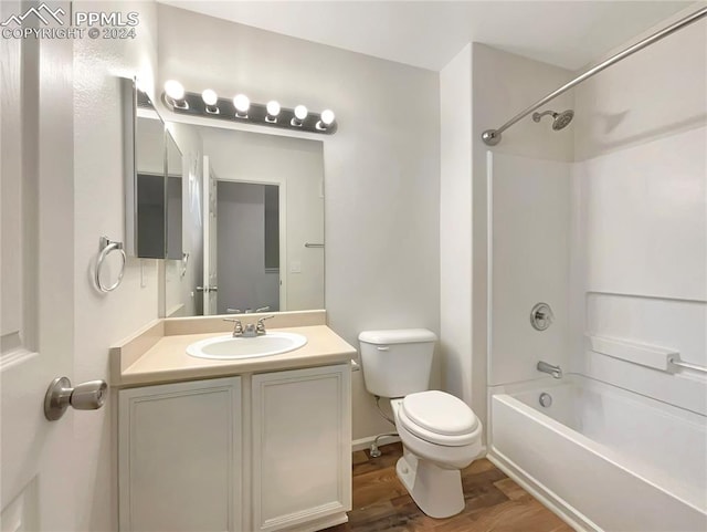 full bathroom with toilet,  shower combination, vanity, and wood-type flooring