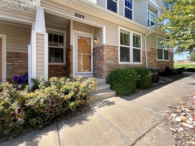 view of exterior entry with a porch