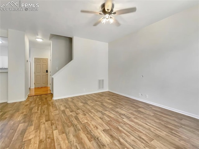 empty room featuring light wood-type flooring and ceiling fan