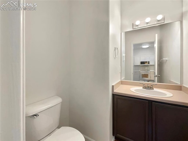 bathroom with toilet and vanity