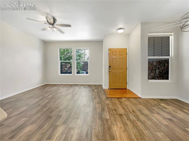 foyer entrance with ceiling fan and hardwood / wood-style flooring