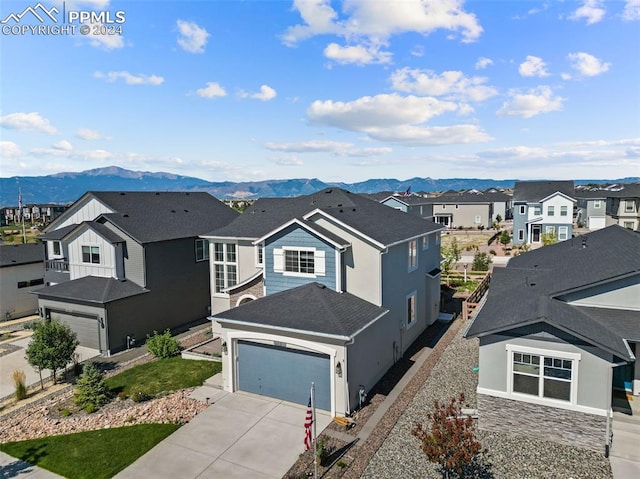 view of front of property with a mountain view and a garage