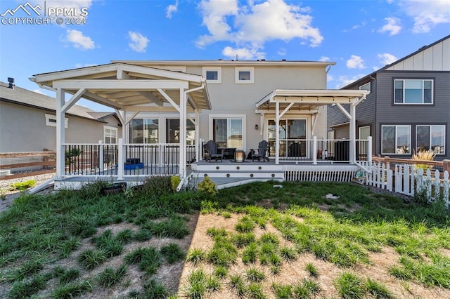 back of property with a wooden deck