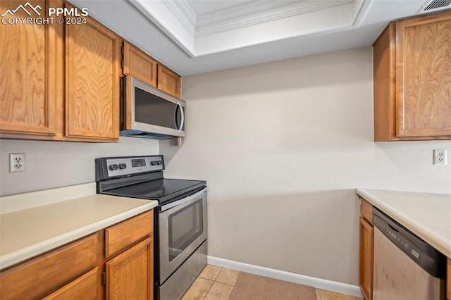 kitchen featuring crown molding, appliances with stainless steel finishes, and light tile patterned flooring