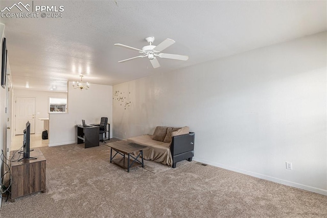 carpeted living room featuring ceiling fan with notable chandelier and a textured ceiling