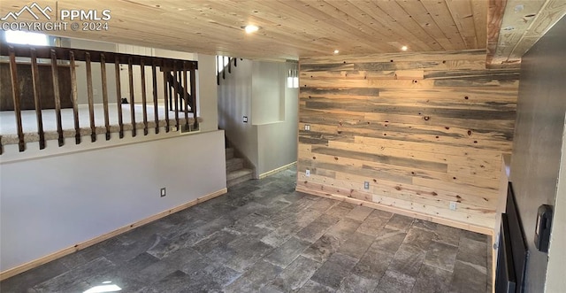 unfurnished room featuring dark hardwood / wood-style floors, wood walls, and wooden ceiling