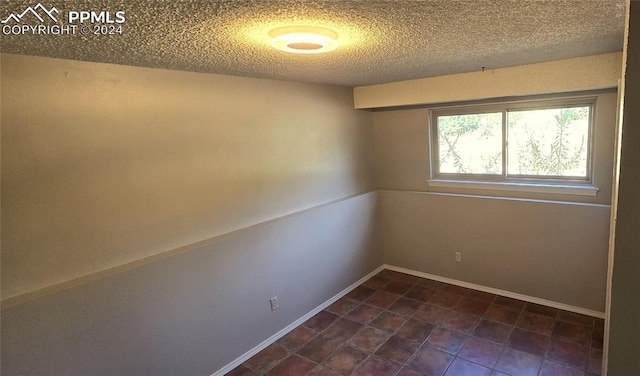 empty room with a textured ceiling