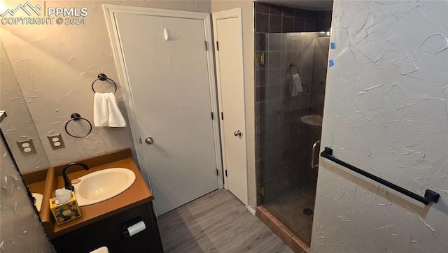 bathroom featuring vanity and an enclosed shower