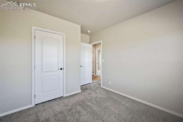 unfurnished bedroom with light carpet