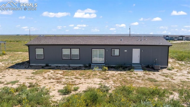 rear view of house featuring cooling unit