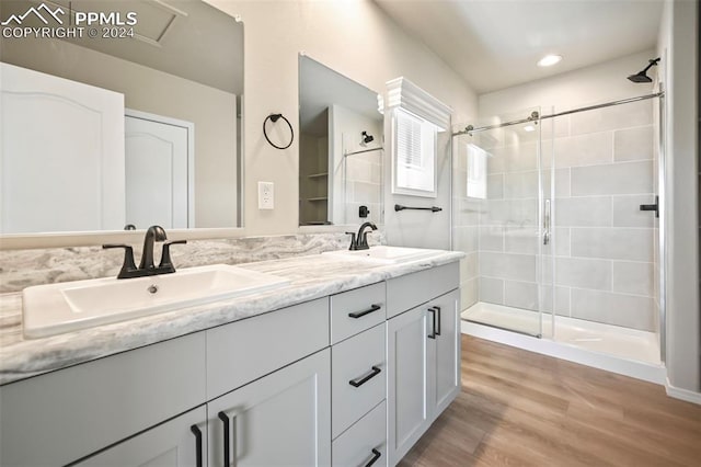 bathroom featuring vanity, a shower with shower door, and hardwood / wood-style flooring