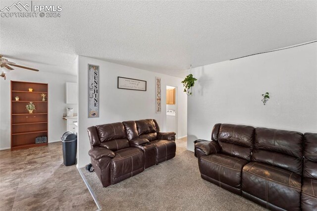 living room featuring a textured ceiling, ceiling fan, and tile patterned flooring