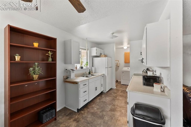 kitchen with washer / clothes dryer, white cabinets, ceiling fan, and a textured ceiling