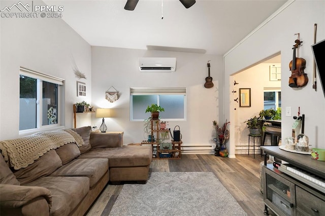 living room with a baseboard heating unit, hardwood / wood-style flooring, a wall mounted air conditioner, and ceiling fan