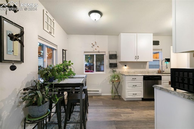 kitchen featuring white cabinets, light stone counters, a baseboard radiator, dark hardwood / wood-style floors, and stainless steel dishwasher