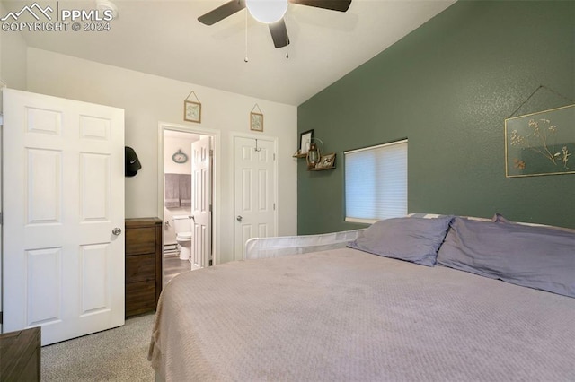 bedroom featuring carpet flooring, ceiling fan, ensuite bath, and vaulted ceiling