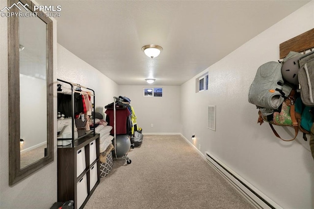 interior space with a baseboard radiator and light carpet