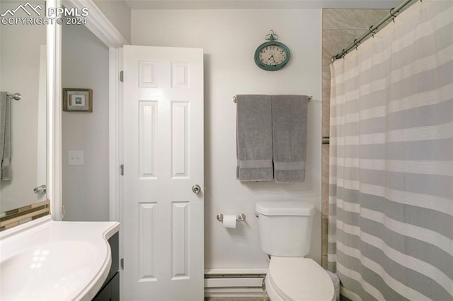 bathroom featuring vanity, toilet, walk in shower, and a baseboard radiator