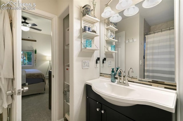 bathroom featuring vanity, ceiling fan, and walk in shower