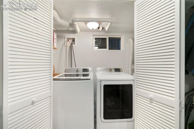 clothes washing area featuring washing machine and dryer