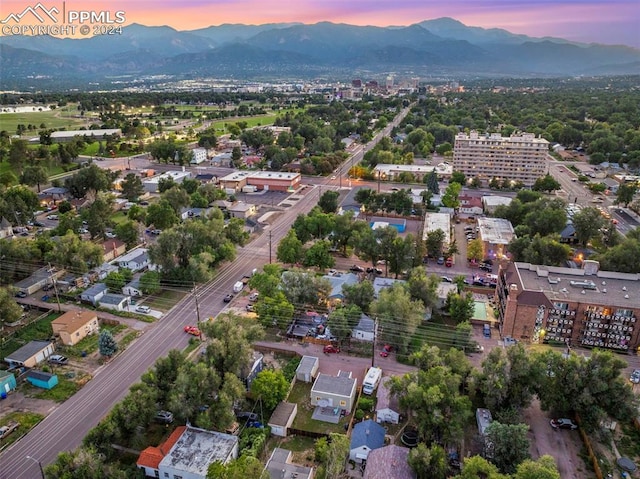 aerial view at dusk featuring a mountain view