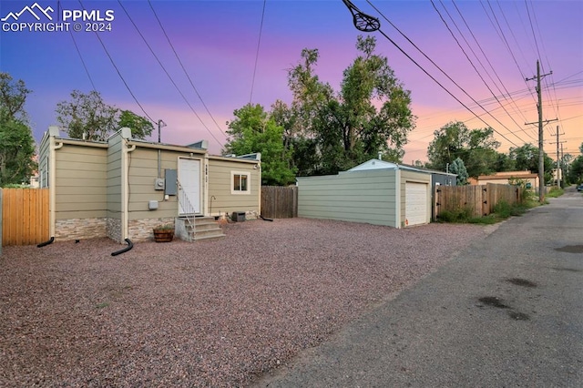 view of front of property with an outdoor structure and a garage