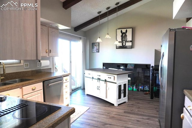 kitchen with light brown cabinetry, appliances with stainless steel finishes, vaulted ceiling with beams, and dark hardwood / wood-style floors