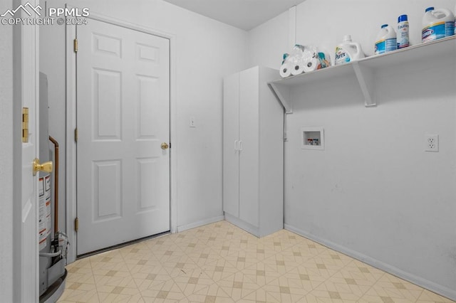 laundry area with hookup for a washing machine and light tile patterned flooring