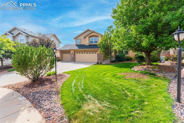 view of front of property with a front yard and a garage