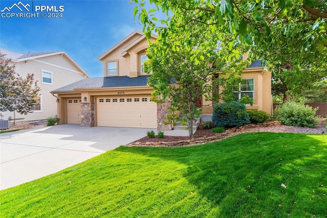 view of front of property featuring central AC, a front yard, and a garage