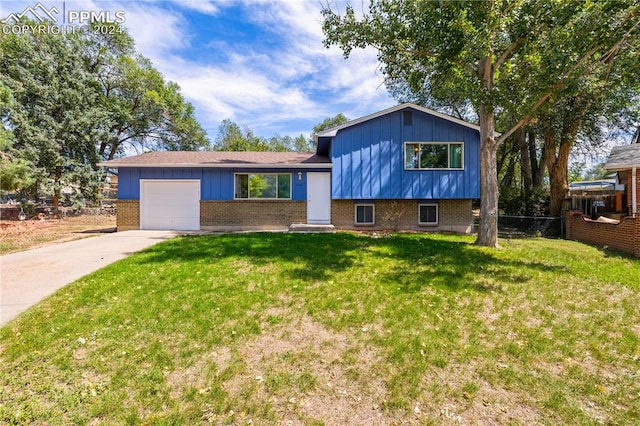 tri-level home featuring a front yard and a garage