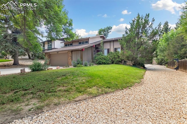 view of front of property featuring a garage and a front yard