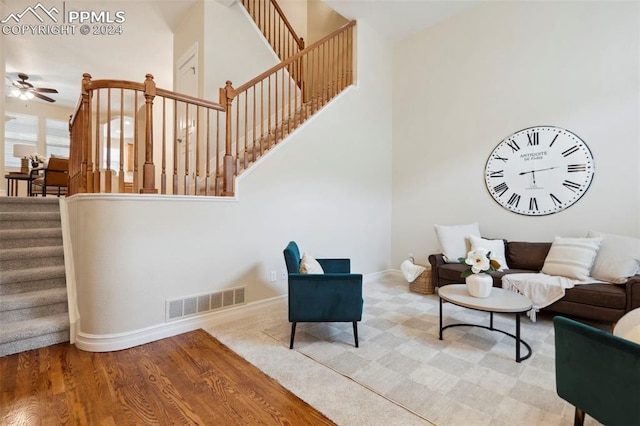 living room with wood-type flooring and ceiling fan