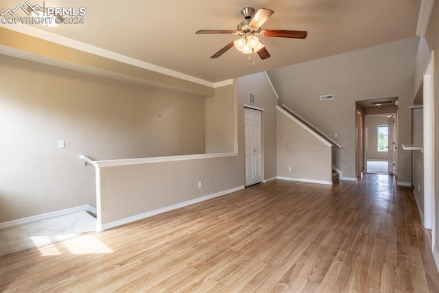 unfurnished room with lofted ceiling, hardwood / wood-style floors, and ceiling fan