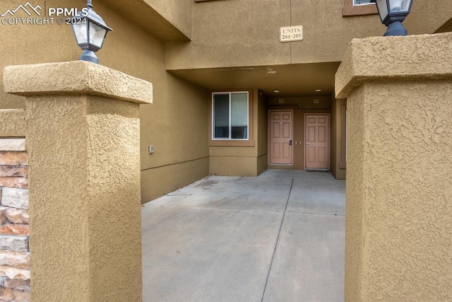 entrance to property featuring stucco siding