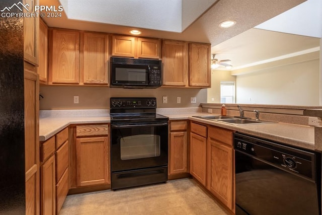 kitchen with ceiling fan, light countertops, black appliances, a sink, and recessed lighting