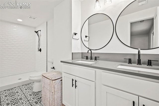 full bathroom featuring toilet, a stall shower, visible vents, and a sink