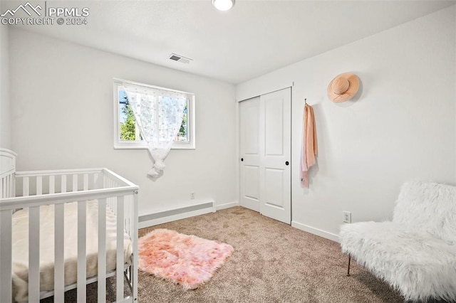 bedroom with baseboards, a closet, visible vents, and carpet flooring