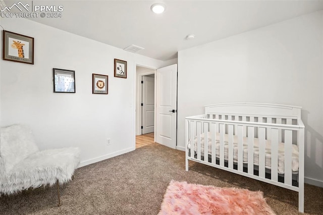 carpeted bedroom with visible vents and baseboards