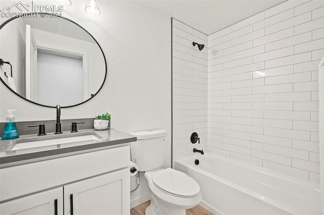 full bathroom with toilet, wood finished floors, bathtub / shower combination, and vanity