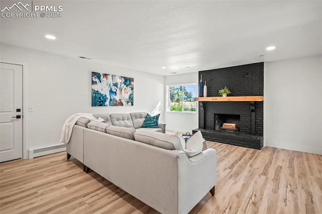 living room with recessed lighting, a brick fireplace, light wood finished floors, and baseboard heating