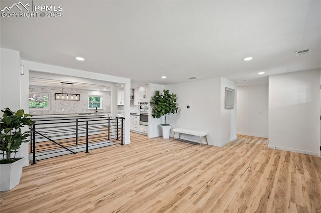 interior space with light wood-type flooring, visible vents, and recessed lighting